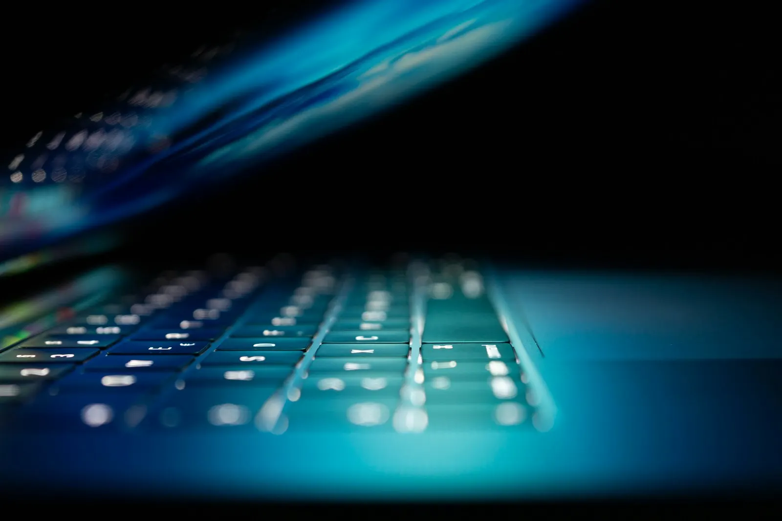 closeup photo of turned-on blue and white laptop computer — illustrative image