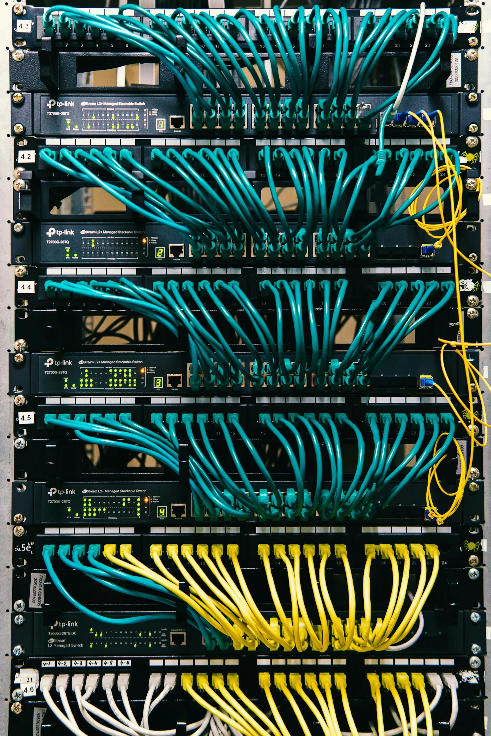 a rack of servers with wires and wires attached to them — illustrative image